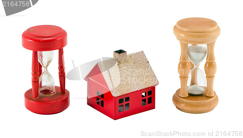 Image of broken sand glass house figure timer run concept 