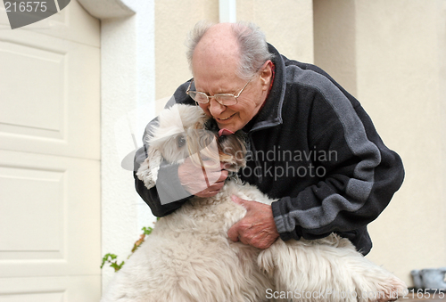 Image of Happy senior man and his dog