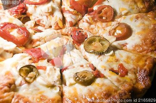 Image of cheese pizza homemade with roasted red peppers hot chilis  garli