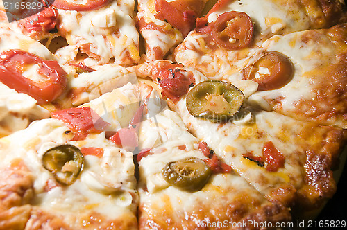 Image of cheese pizza homemade with roasted red peppers hot chilis  garli