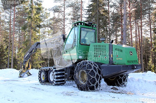 Image of Green Wheeled Harvester by Forest Logging Site