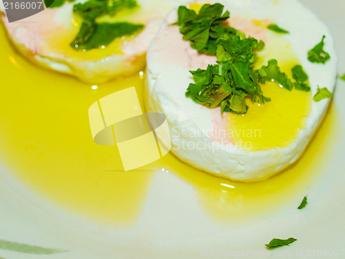 Image of Tomino cheese with rucola and olive oil