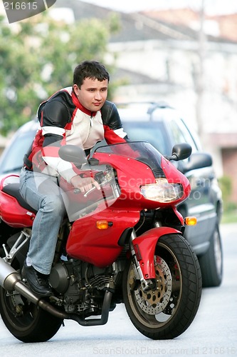 Image of Man on a red bike