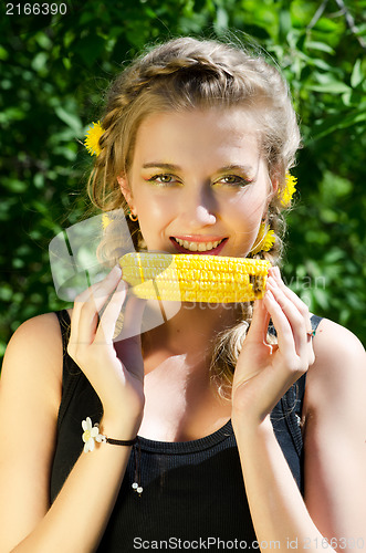 Image of woman eating corn-cob