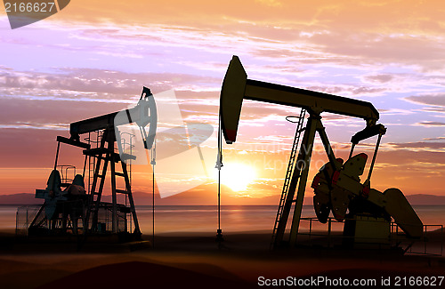 Image of oil pumps on sunset