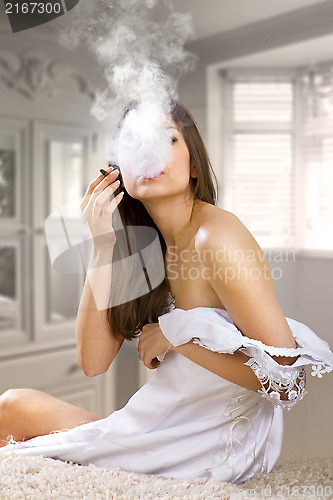 Image of woman smokes a cigaret