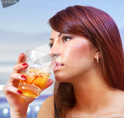 Image of woman with glass of whisky