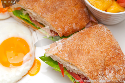 Image of ciabatta panini sandwich eggs tomato lettuce