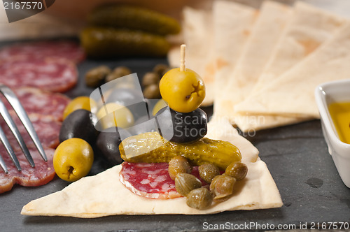 Image of cold cut platter with pita bread and pickles