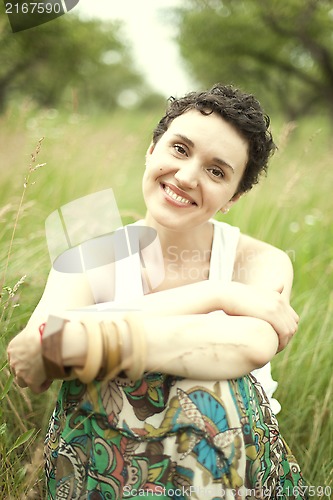 Image of cute girl resting on fresh spring grass 