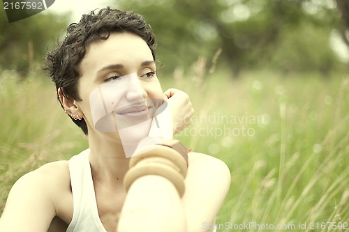 Image of cute girl on green field 