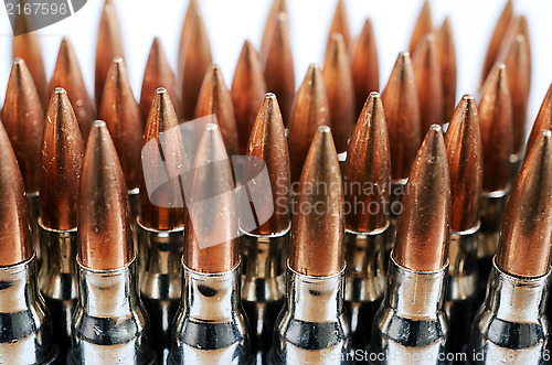 Image of chain of bullets over white, closeup