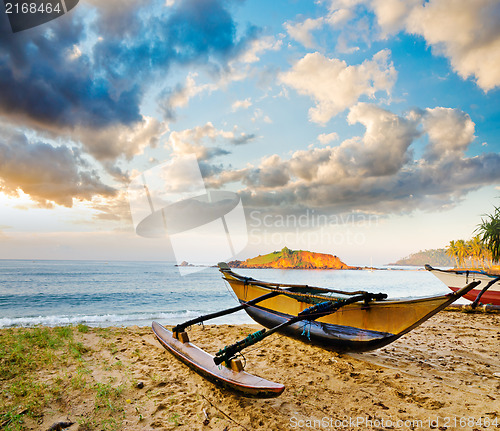 Image of fishing boat  against sunset background