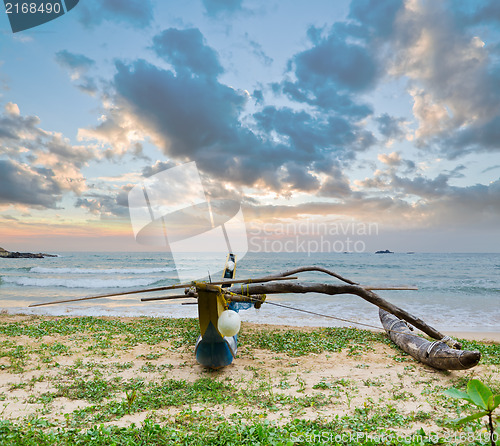Image of fishing boat  against sunset background