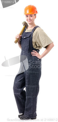 Image of manual worker in overalls with a hammer