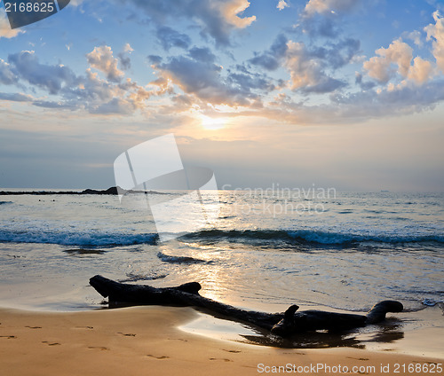 Image of meditation in front of ocean waves and the low sun