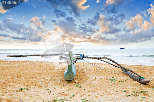 Image of fishing boat  against sunset background