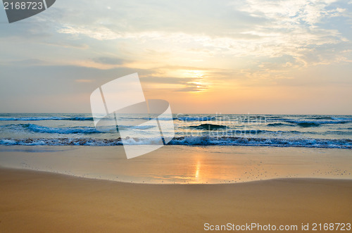 Image of meditation in front of ocean waves and the low sun