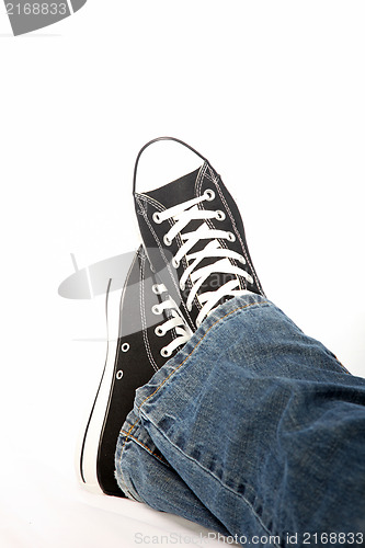 Image of Person in jeans and sneakers