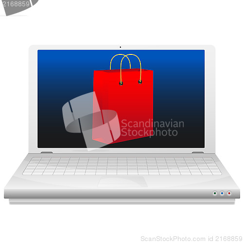 Image of On line shopping concept. Red shopping bag at laptop screen.