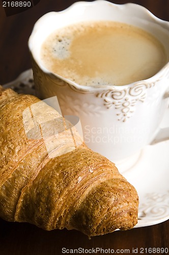 Image of breakfast with cup of black coffee and croissants