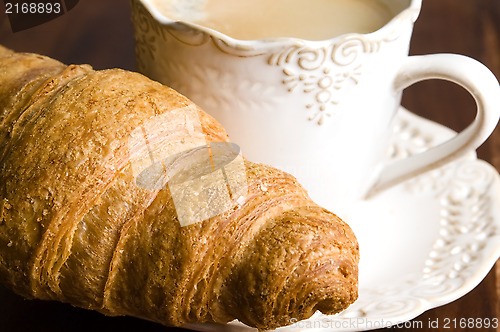 Image of breakfast with cup of black coffee and croissants