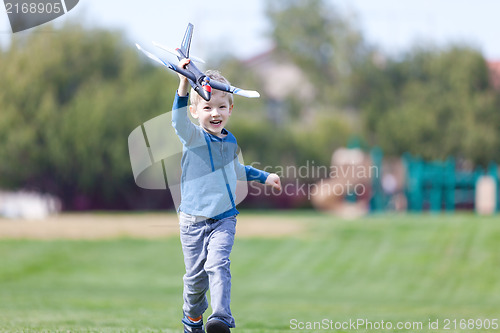 Image of child playing with a plane