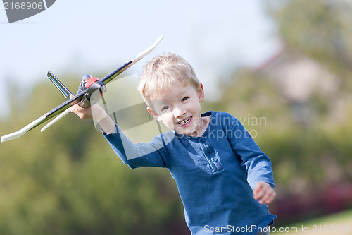 Image of child playing with a plane