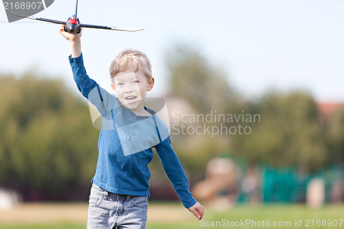 Image of child playing with a plane