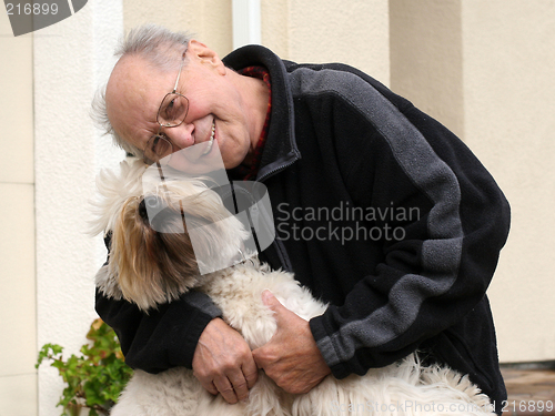 Image of Happy senior man and his dog