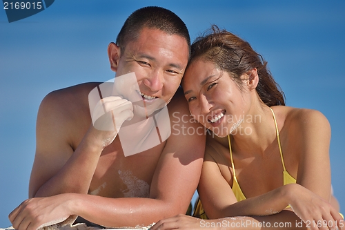 Image of happy young  couple enjoying summer on beach