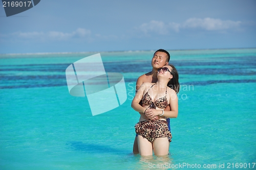 Image of happy young  couple enjoying summer on beach