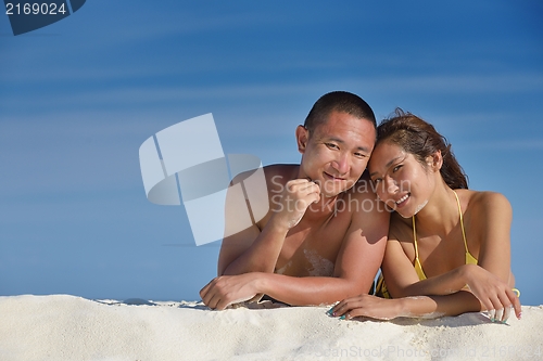 Image of happy young  couple enjoying summer on beach