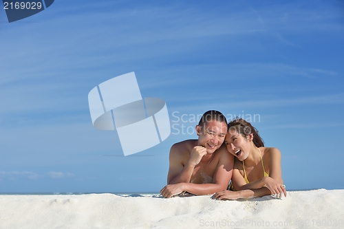 Image of happy young  couple enjoying summer on beach