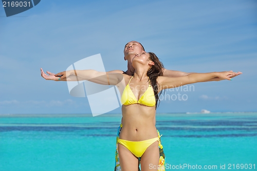 Image of happy young  couple enjoying summer on beach