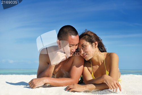 Image of happy young  couple enjoying summer on beach