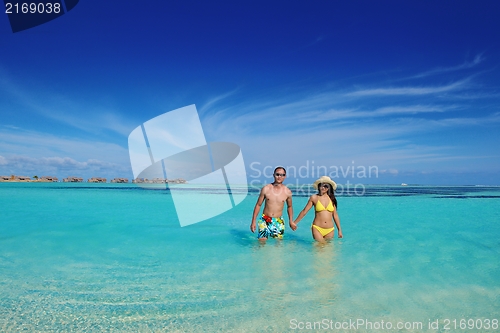 Image of happy young  couple enjoying summer on beach