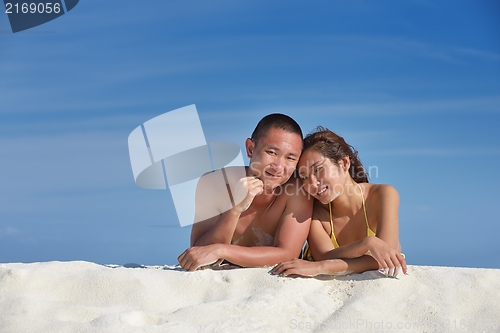Image of happy young  couple enjoying summer on beach