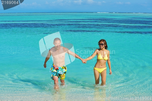 Image of happy young  couple enjoying summer on beach