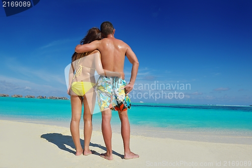 Image of happy young  couple enjoying summer on beach