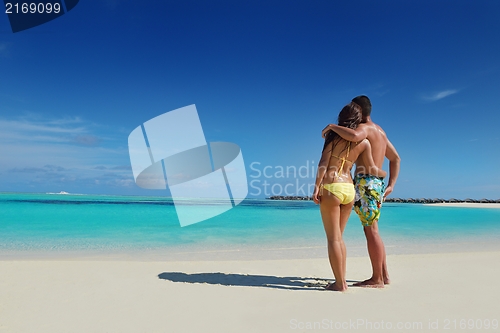 Image of happy young  couple enjoying summer on beach