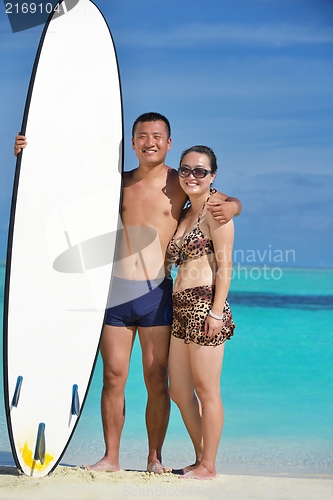 Image of happy young  couple enjoying summer on beach