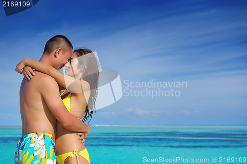 Image of happy young  couple enjoying summer on beach