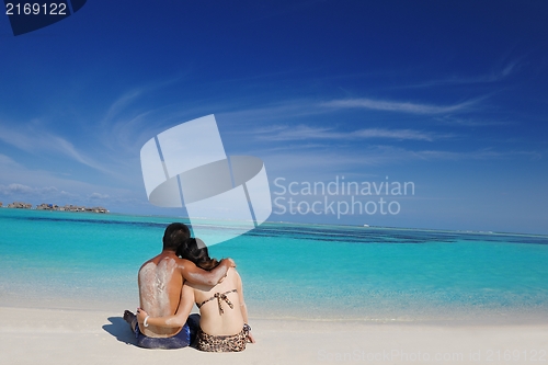 Image of happy young  couple enjoying summer on beach