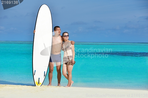 Image of happy young  couple enjoying summer on beach