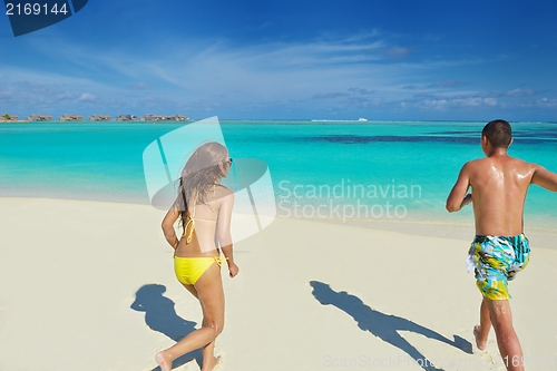 Image of happy young  couple enjoying summer on beach