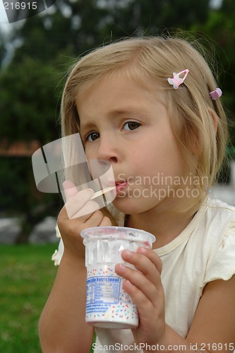 Image of the girl eats ice-cream