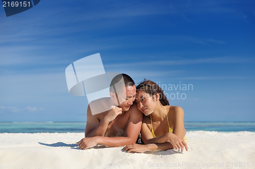 Image of happy young  couple enjoying summer on beach