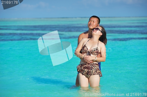 Image of happy young  couple enjoying summer on beach