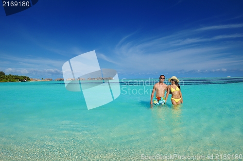 Image of happy young  couple enjoying summer on beach